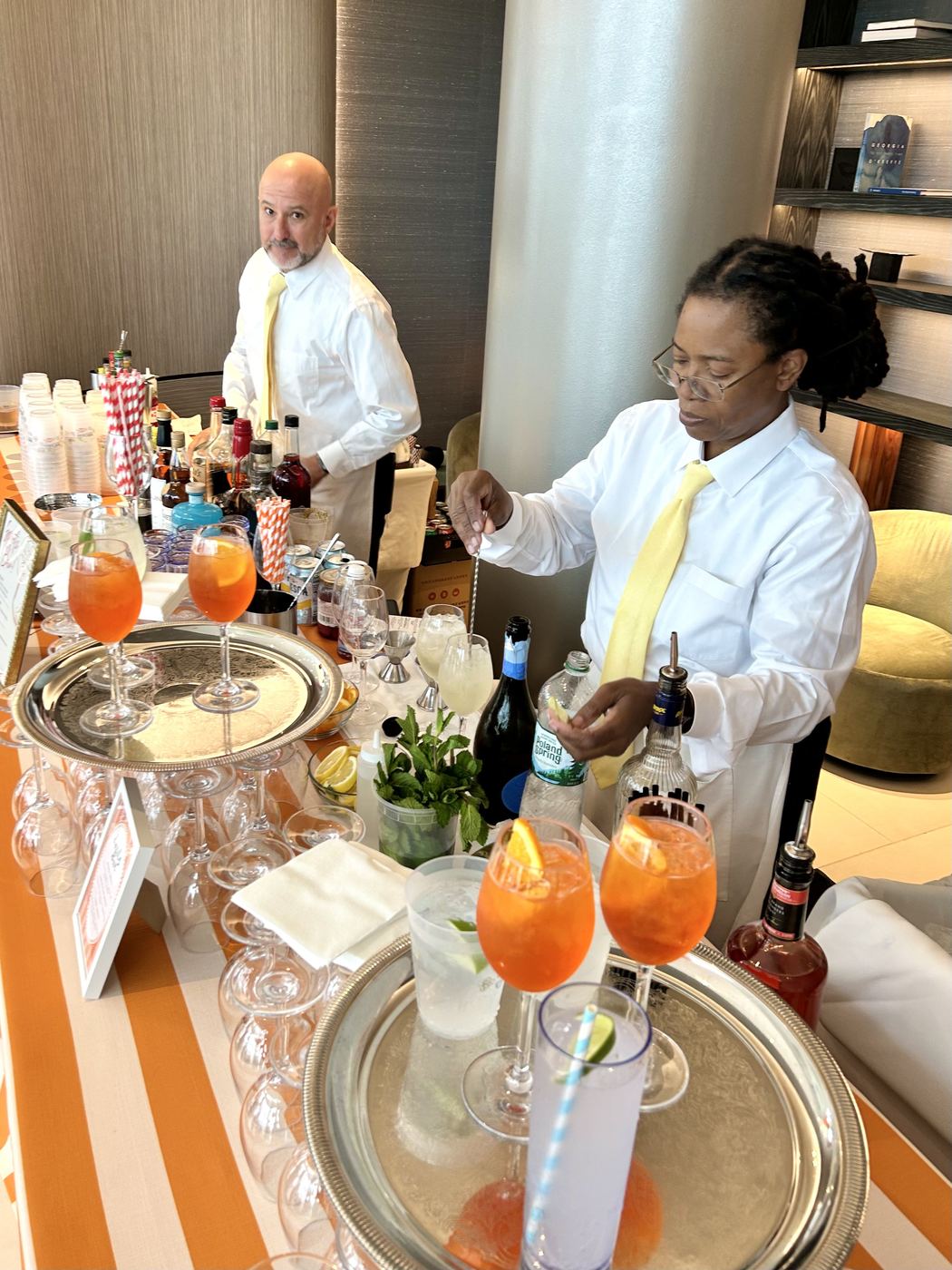 Bartenders preparing cocktails at an event bar